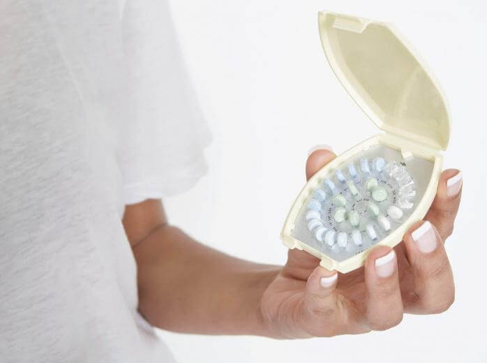 woman holding pills