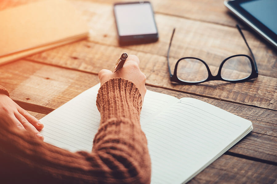 Woman writing in a journal